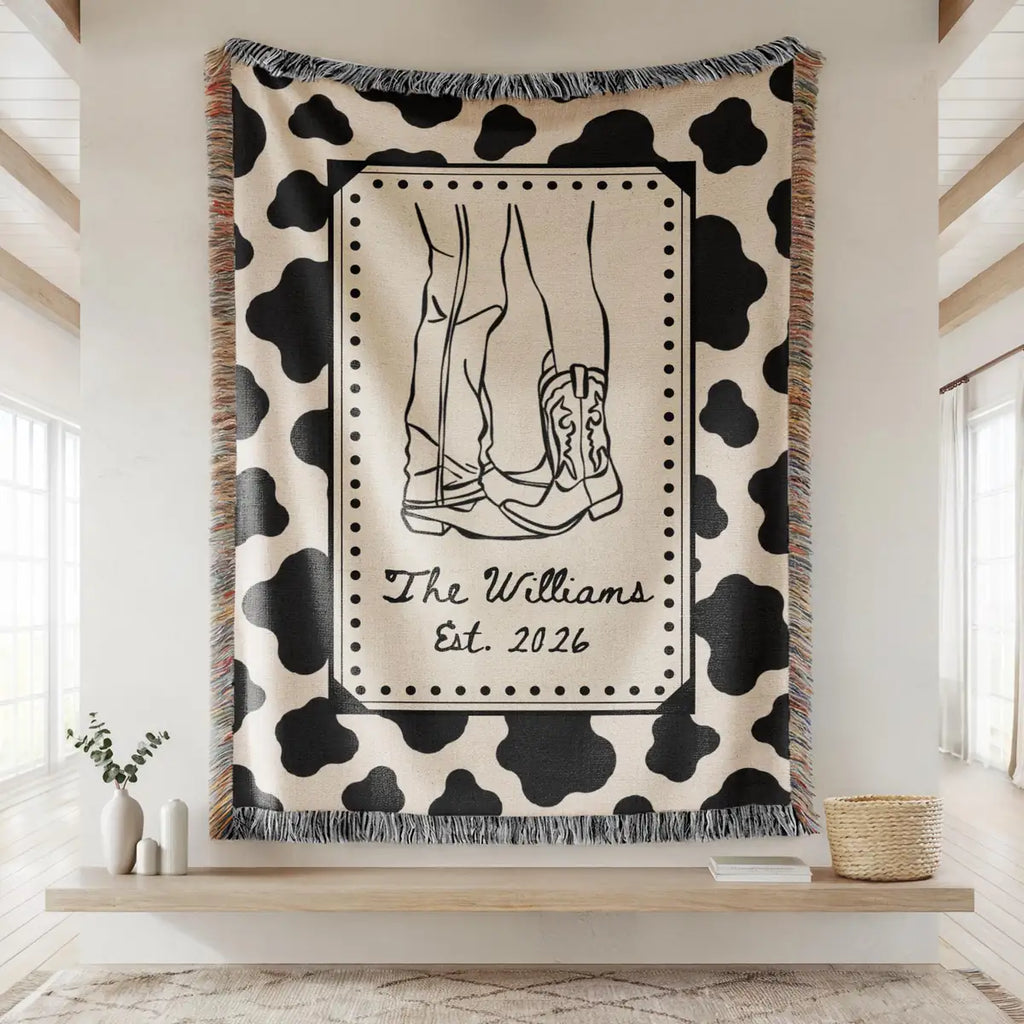 Personalized cow print western woven blanket shown in a styled room setting