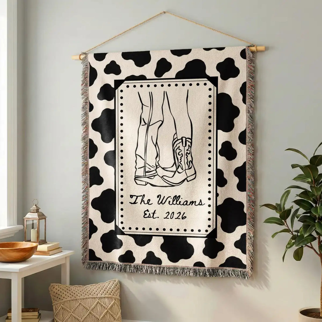Personalized cow print western woven blanket shown in a styled room setting