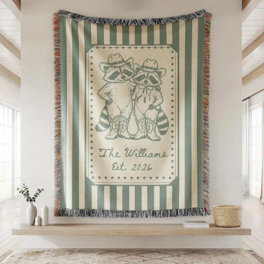 Close-up of the personalized cowboy raccoon striped woven blanket with texture and fringe detail