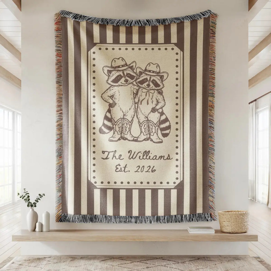 Close-up of the personalized cowboy raccoon striped woven blanket with texture and fringe detail