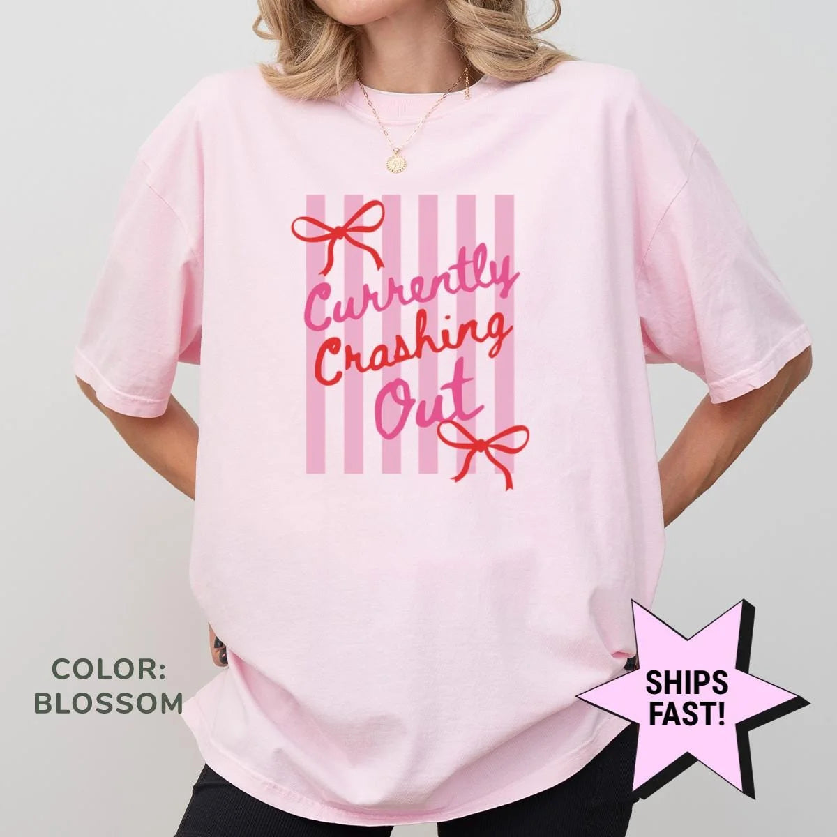 Woman in a Blossom pink Comfort Colors tee, hands on hips, with red currently crashing out and bows on pink stripes