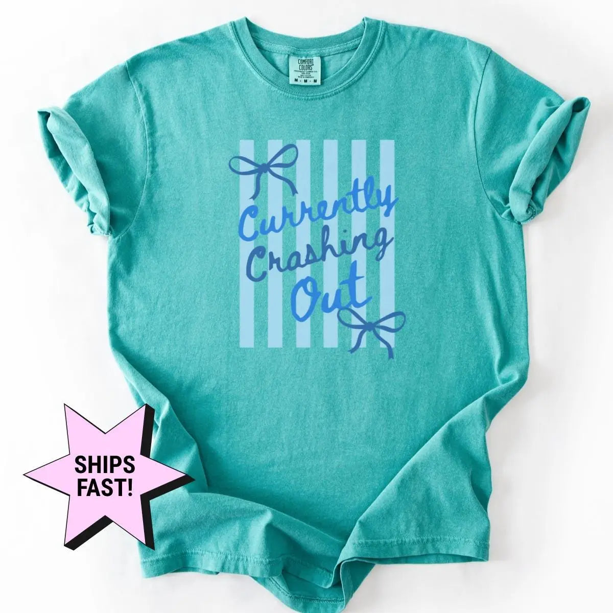 Seafoam teal Comfort Colors tee with sleeves rolled, flat on white, blue currently crashing out and bows over pale stripes
