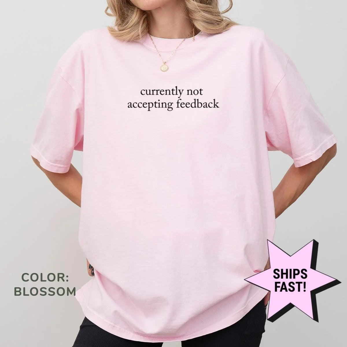 Woman in a Blossom pink Comfort Colors tee with currently not accepting feedback in dark serif type on the chest