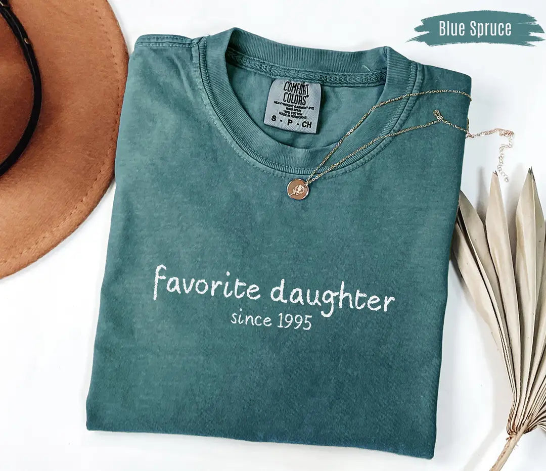 Blue Spruce Comfort Colors T-shirt with white 'Favorite daughter since [year]' custom-year design.