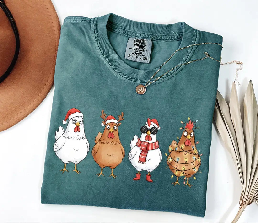 Blue Spruce Comfort Colors T-shirt with four Christmas chickens wearing holiday costumes.