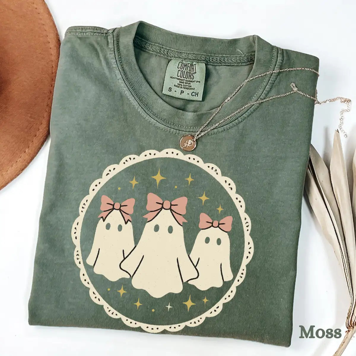 Comfort Colors T-shirt flatlay folded in Moss color featuring cute ghosts with pink bows graphic