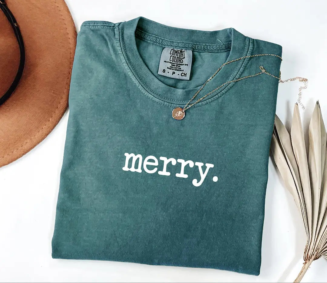 Blue Spruce Comfort Colors T-shirt with minimal white 'merry.' Christmas lettering.