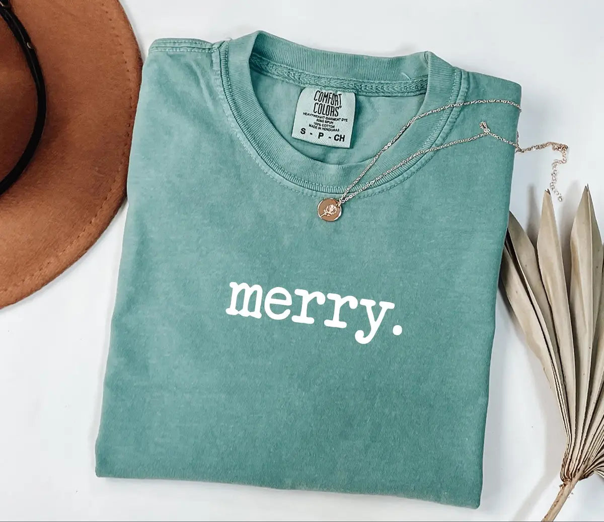 Seafoam Comfort Colors 1717 tee with a simple white lowercase 'merry.' graphic.