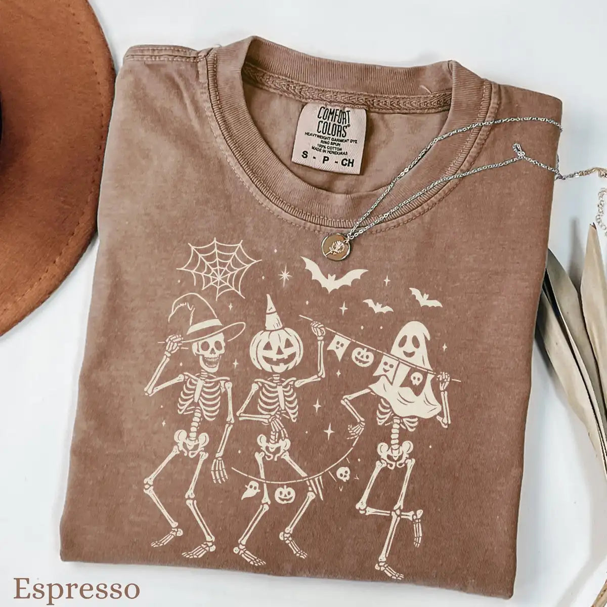 Comfort Colors T-shirt in Pepper color featuring dancing skeletons holding banner graphic