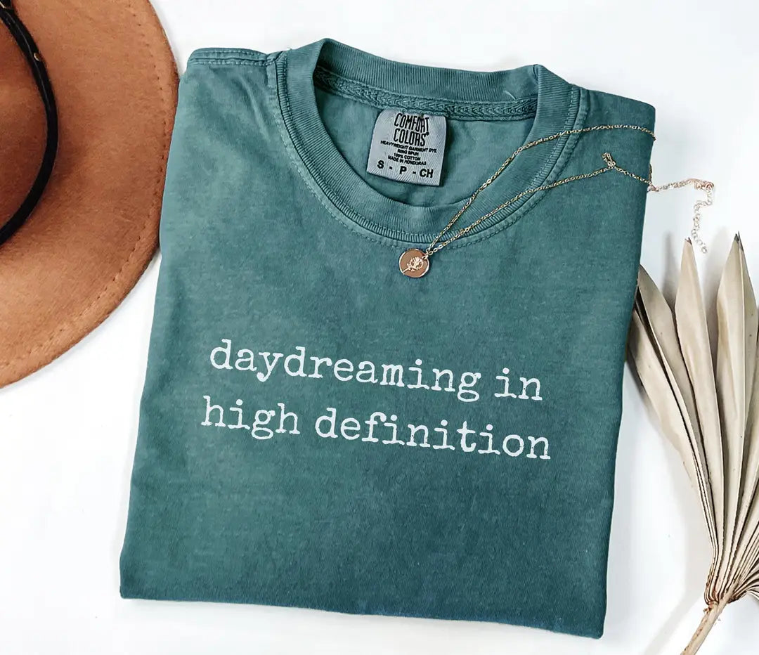 Blue Spruce Comfort Colors T-shirt with white 'daydreaming in high definition' typography.