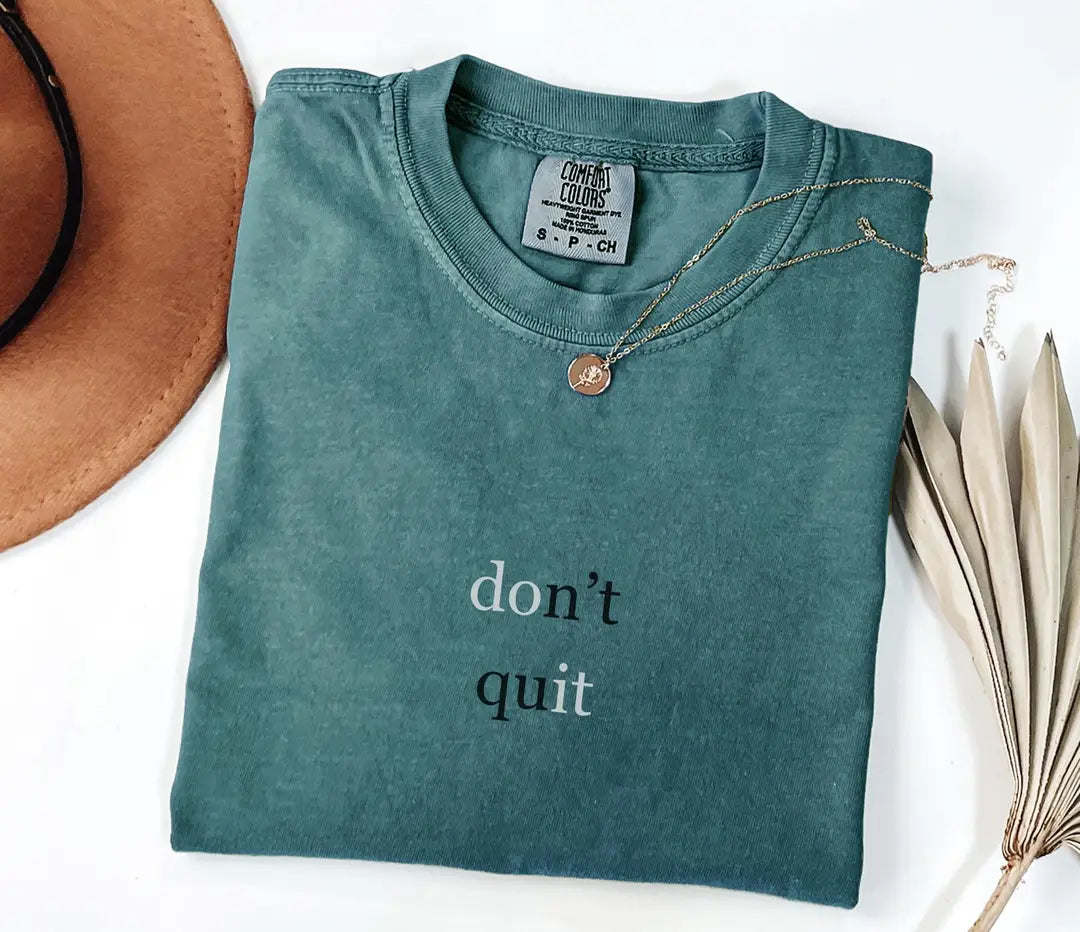 Blue Spruce Comfort Colors T-shirt with 'don't quit' motivational text, folded mockup.