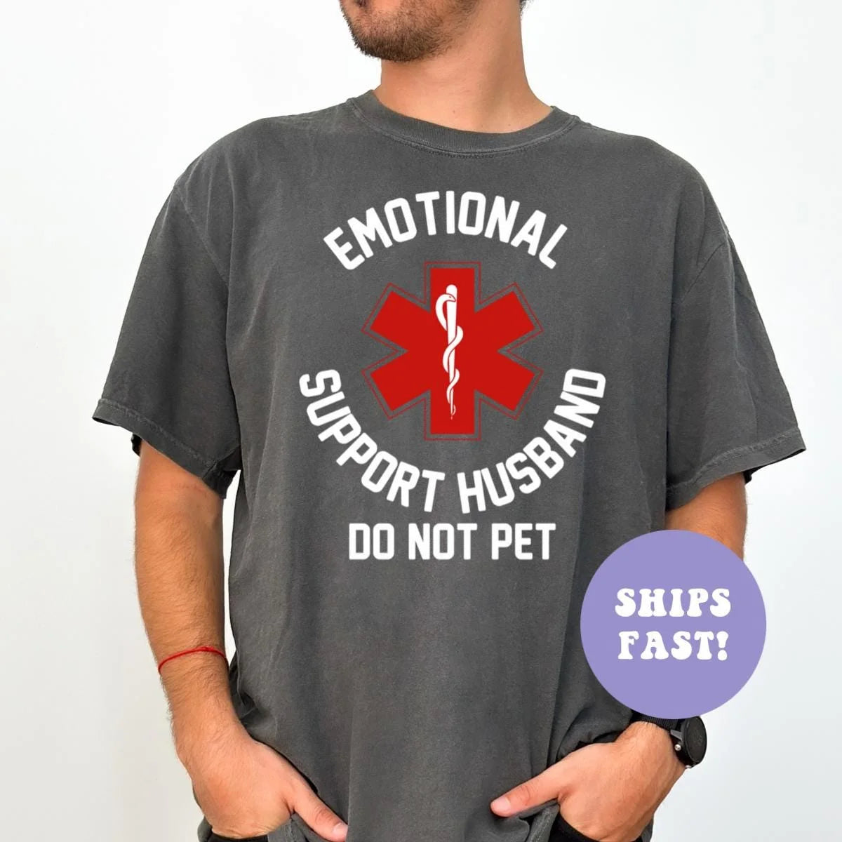 Man in a Pepper Comfort Colors tee with a red medical star in circular white lettering reading emotional support husband
