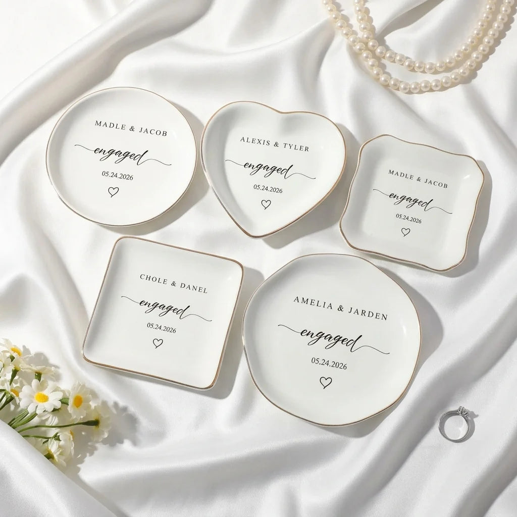 Personalized engaged script ring dish on white satin with engagement ring