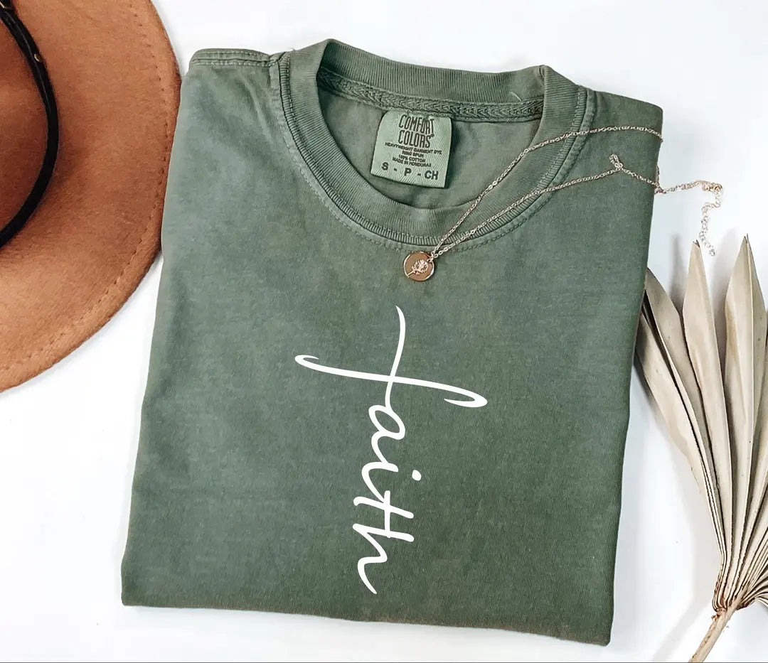 Moss Comfort Colors 1717 tee with a white calligraphy Faith design shaped around a cross.