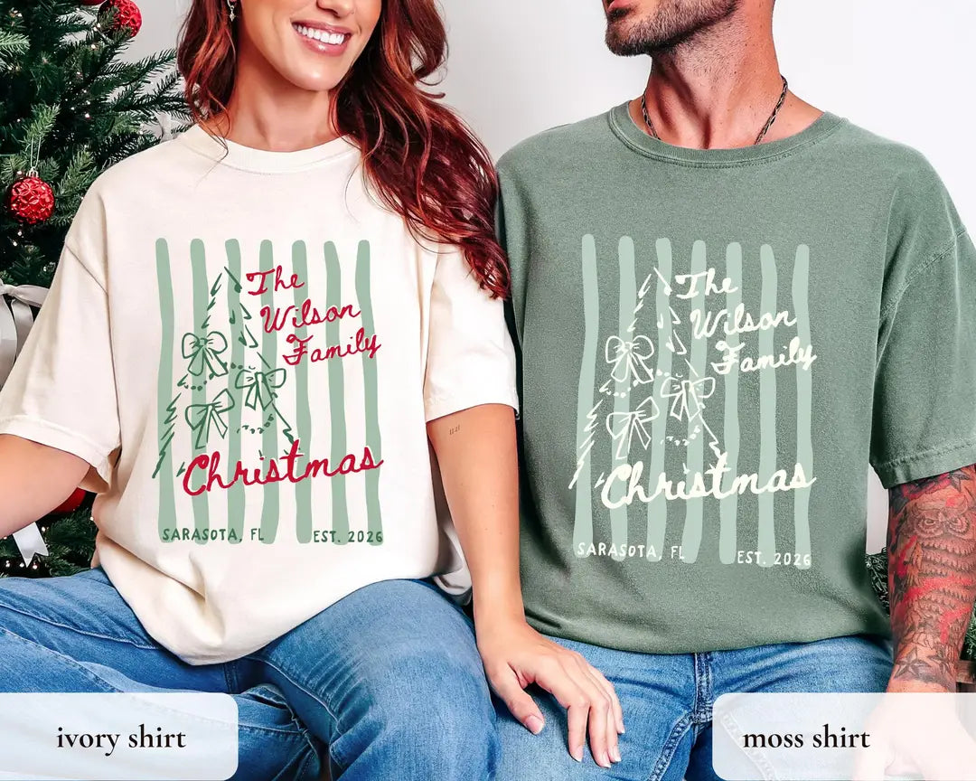 Woman and man on a couch in Ivory and Moss Comfort Colors tees, The Wilson Family Christmas, bow tree and stripes