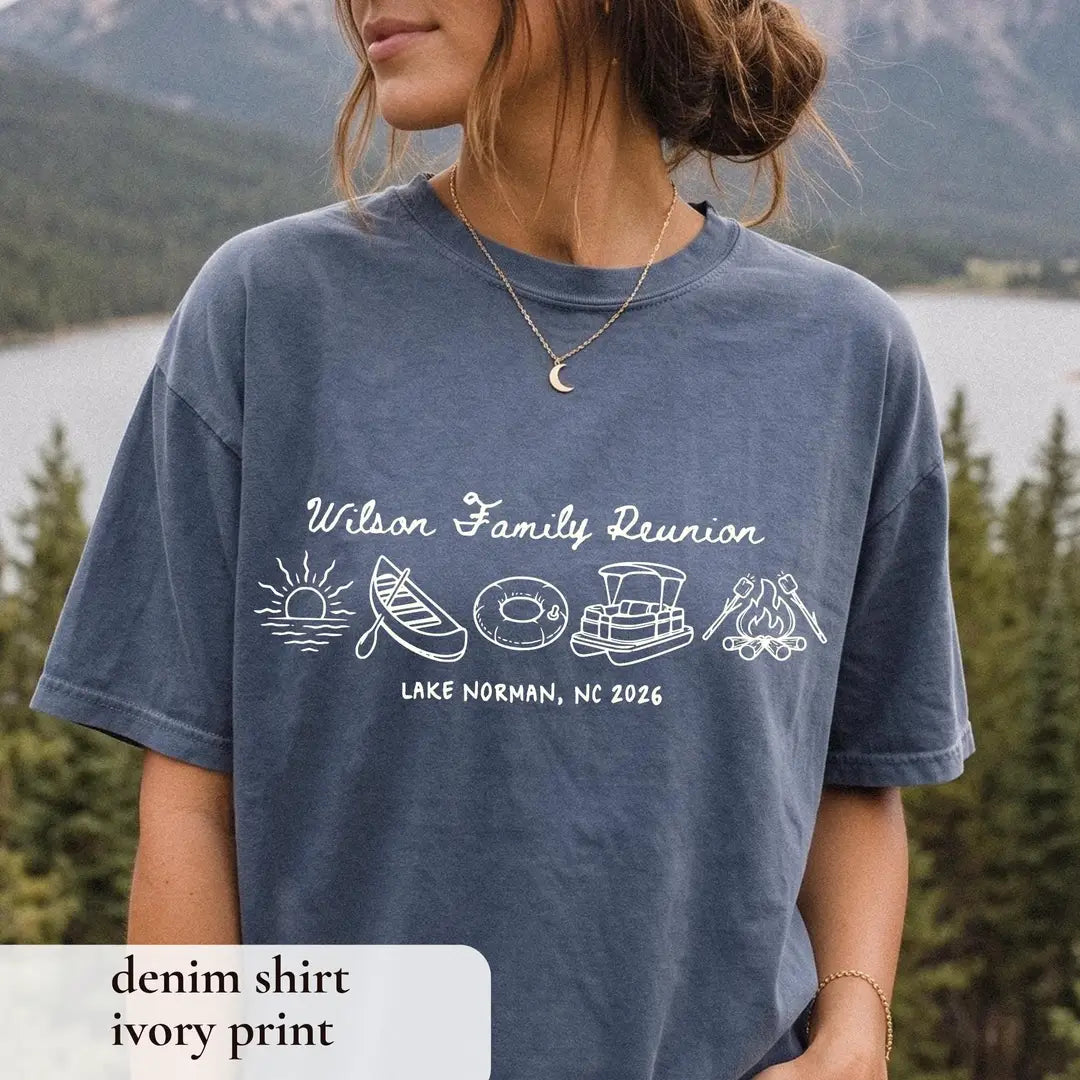Woman in a Denim Comfort Colors tee above a mountain lake, ivory Wilson Family Reunion with canoe and pontoon icons