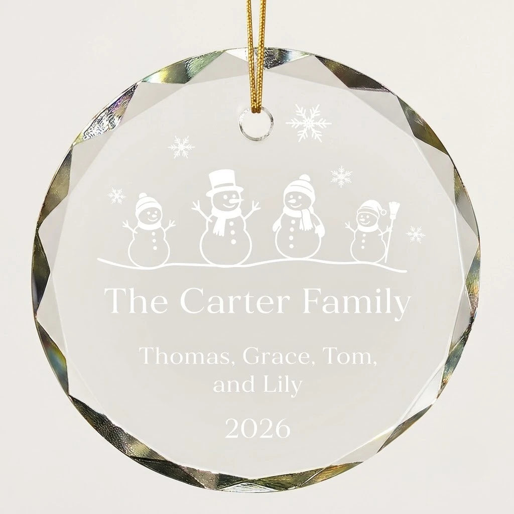 Beveled edge clear glass round ornament featuring printed four snowmen family row graphics, custom text The Carter Family and personalized details hanging on gold ribbon