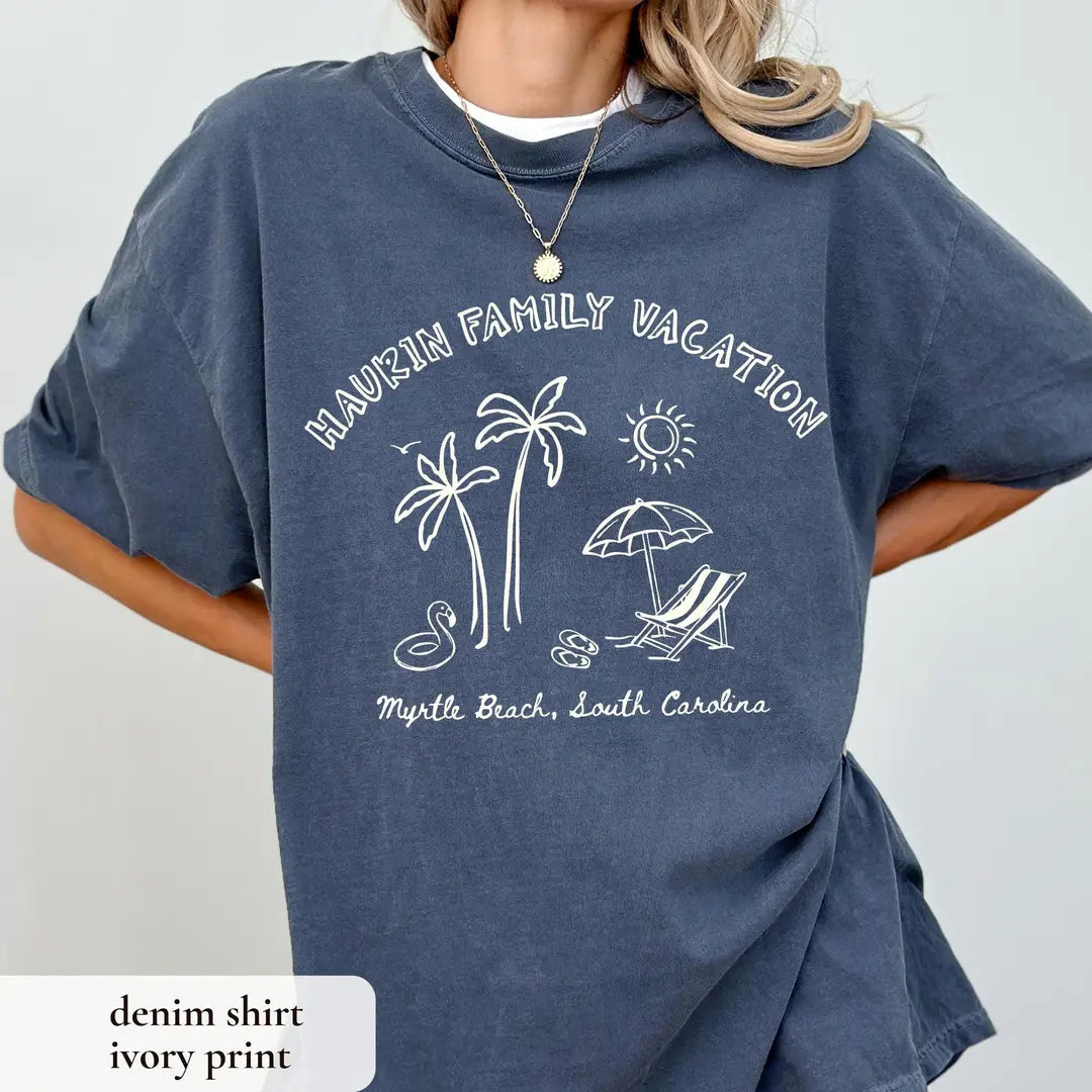Woman in a Denim Comfort Colors tee and a white undershirt, hand on hip, ivory arched family vacation over palms and umbrella
