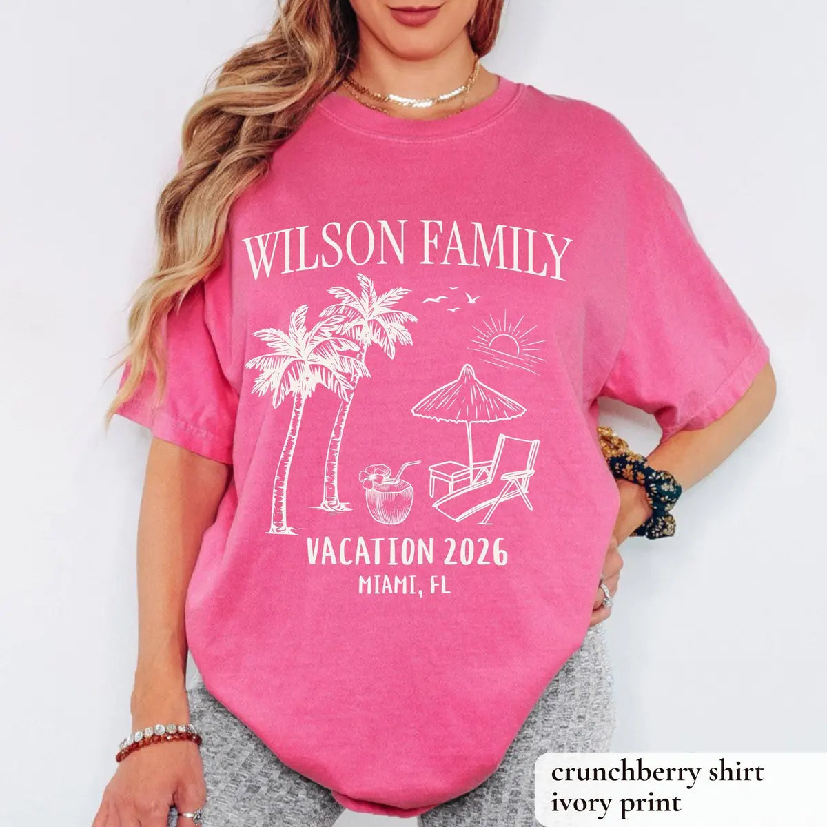 Woman in a Crunchberry Comfort Colors tee, hand on hip, white Wilson Family over palm trees and Vacation 2026