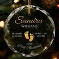 Clear glass round ornament featuring gold baby footprints and custom birth statistics details with detail view