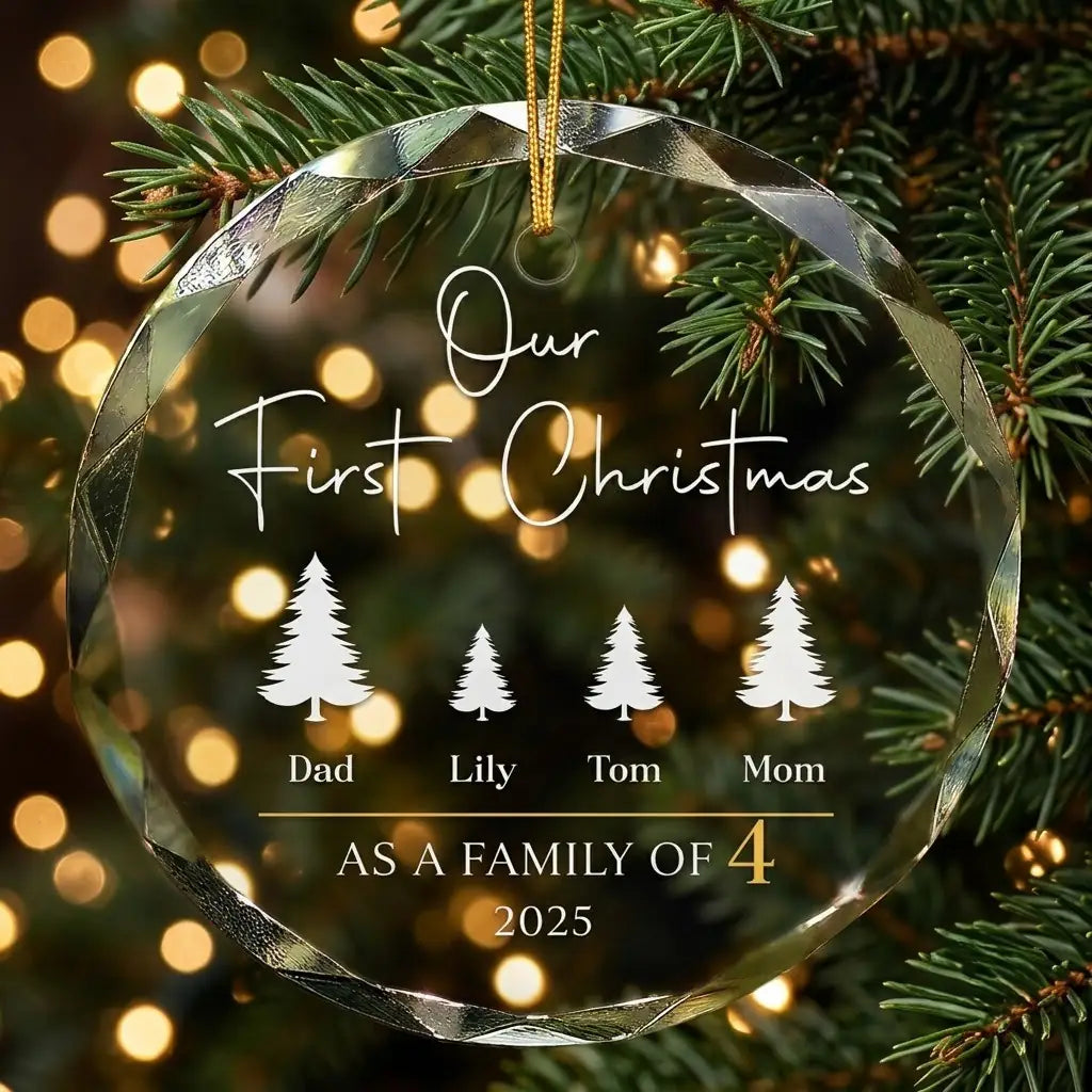 Personalized clear glass family of 4 ornament displayed hanging on Christmas tree branch with warm sparkling holiday lights background