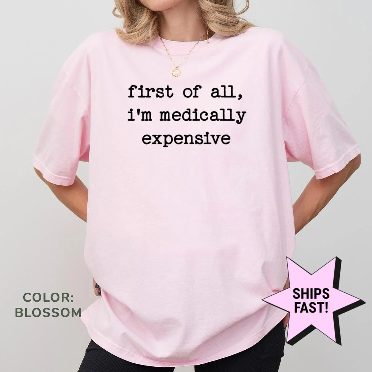 Woman in a Blossom pink Comfort Colors tee with first of all, i'm medically expensive in black typewriter type