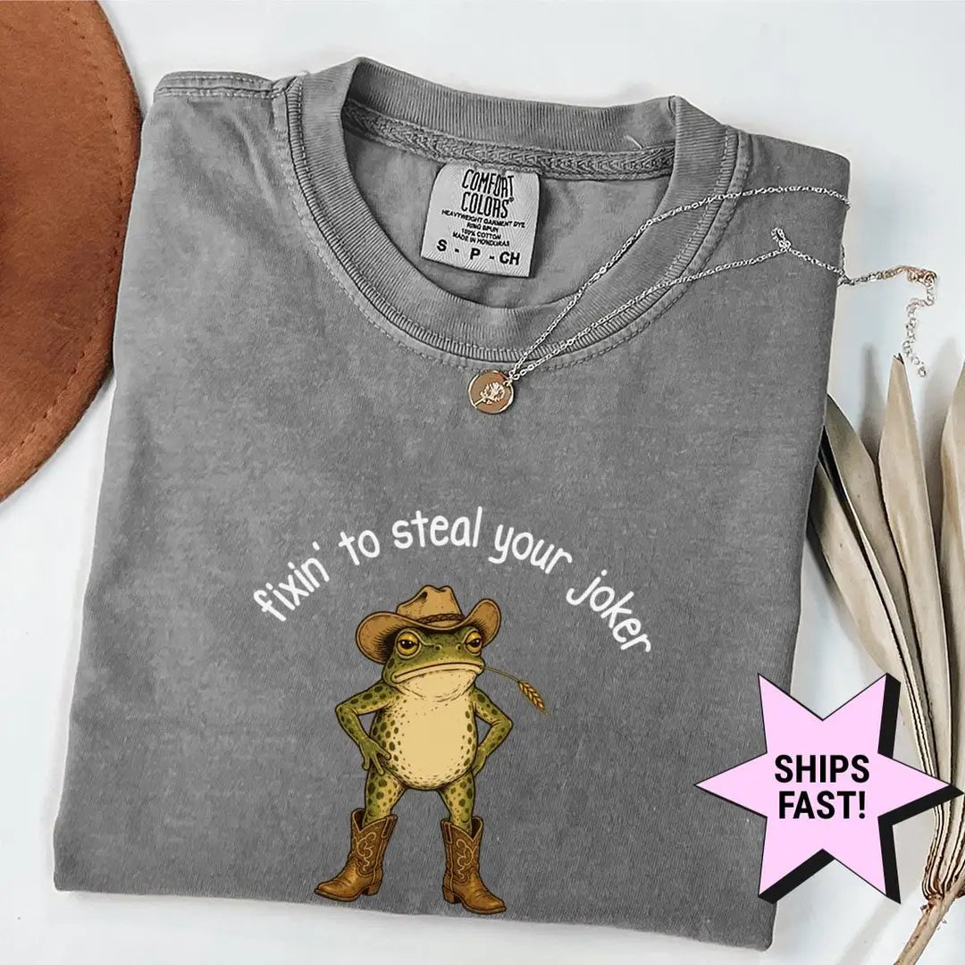 Folded Pepper Comfort Colors tee with a cowboy frog in boots and a hat under arched text, fixin' to steal your joker