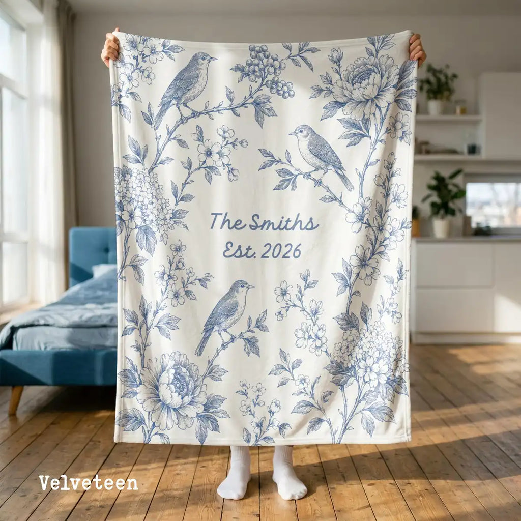 Personalized floral bird panel woven blanket shown in a styled room setting