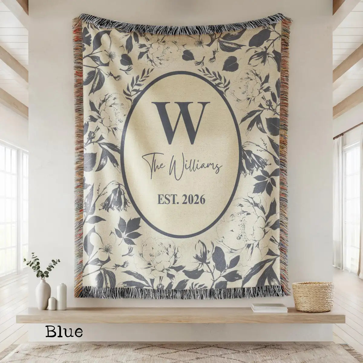 Close-up of the personalized floral toile woven blanket with monogram and fringe detail