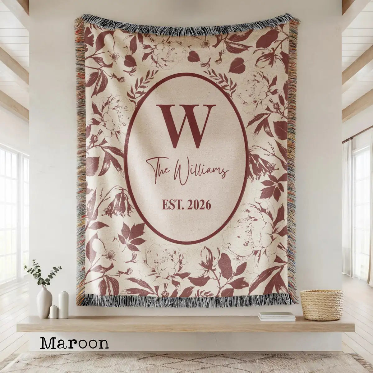 Close-up of the personalized floral toile woven blanket with monogram and fringe detail