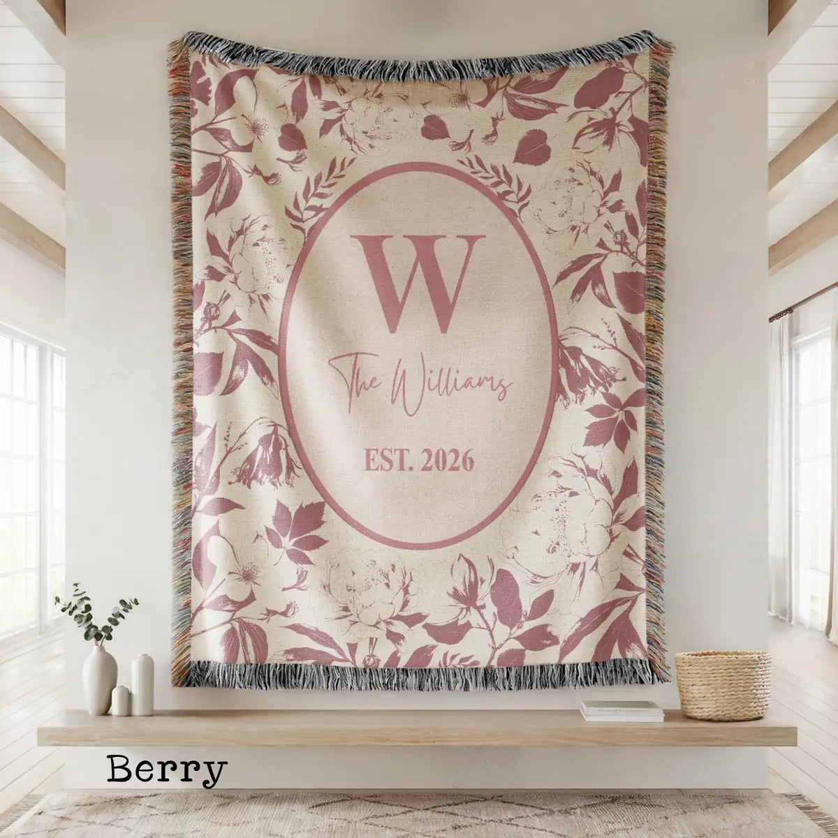 Close-up of the personalized floral toile woven blanket with monogram and fringe detail