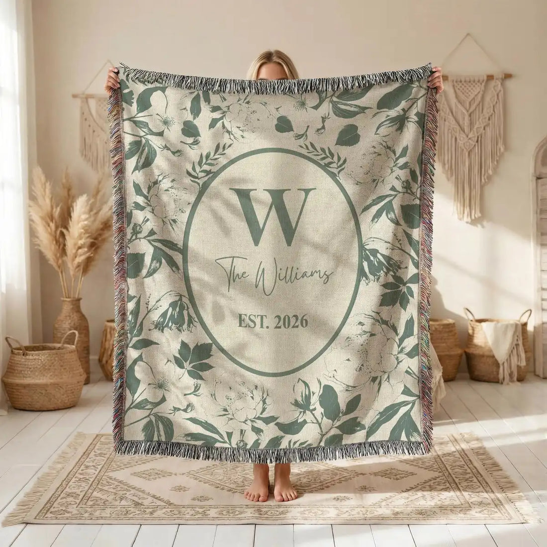 Close-up of the personalized floral toile woven blanket with monogram and fringe detail