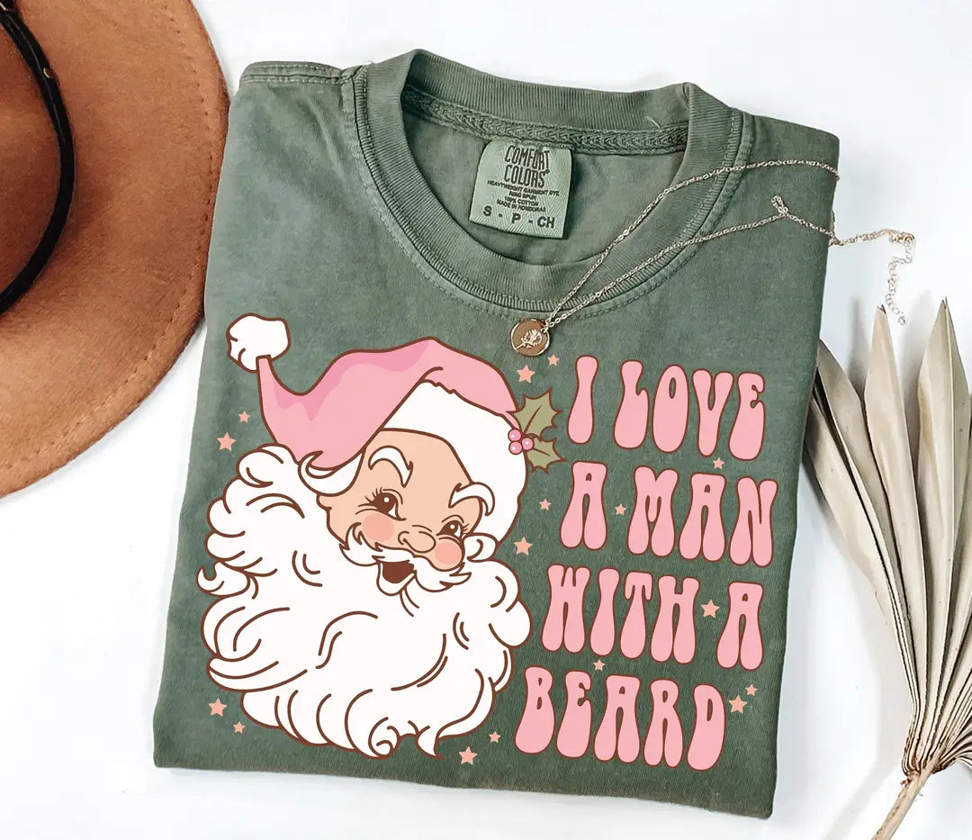 Moss Comfort Colors T-shirt with illustrated Santa in a pink hat and I Love a Man with a Beard lettering.
