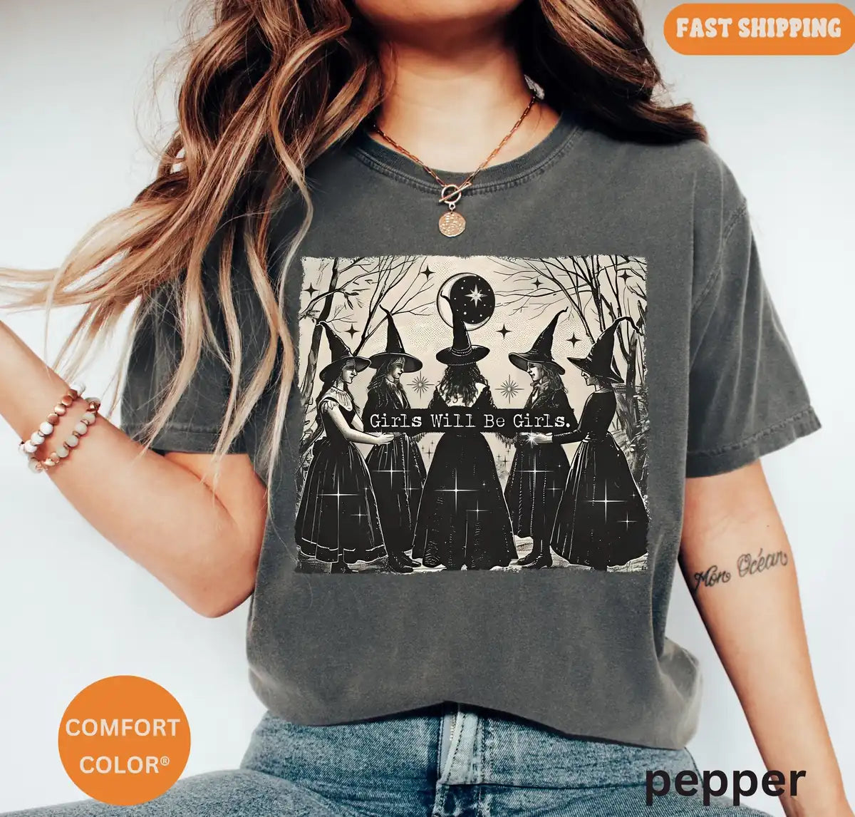 Comfort Colors T-shirt in Pepper color worn by model featuring vintage Girls Will Be Girls witch circle graphic