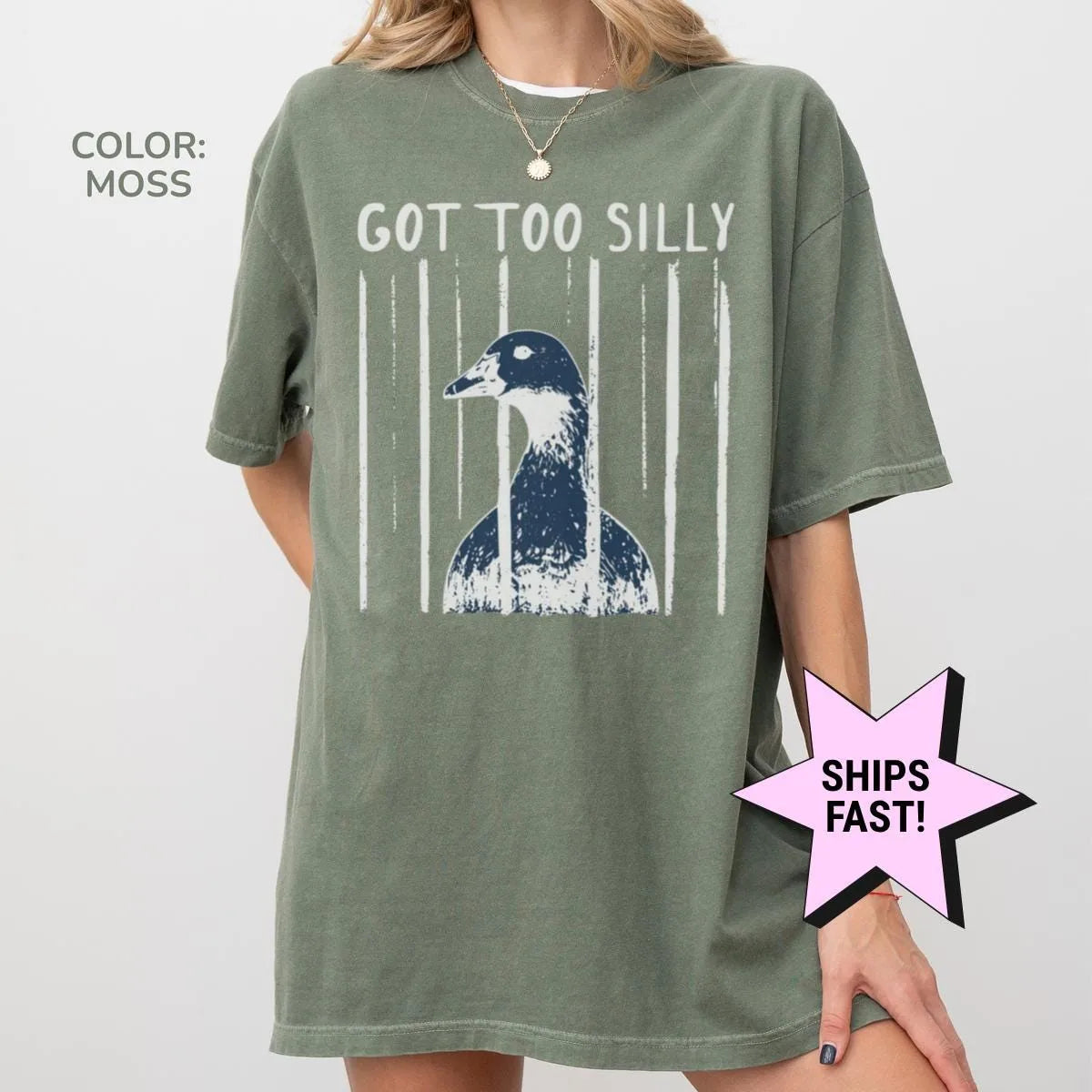 Woman in a Moss green Comfort Colors tee, hand at her side, with got too silly and a goose head framed by pale stripes