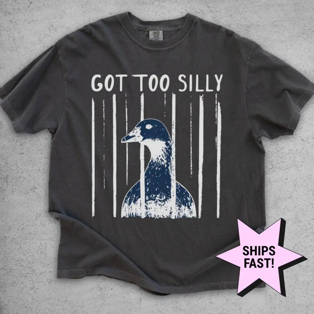 Pepper Comfort Colors tee flat on gray concrete with got too silly above a goose head framed by white brush stripes