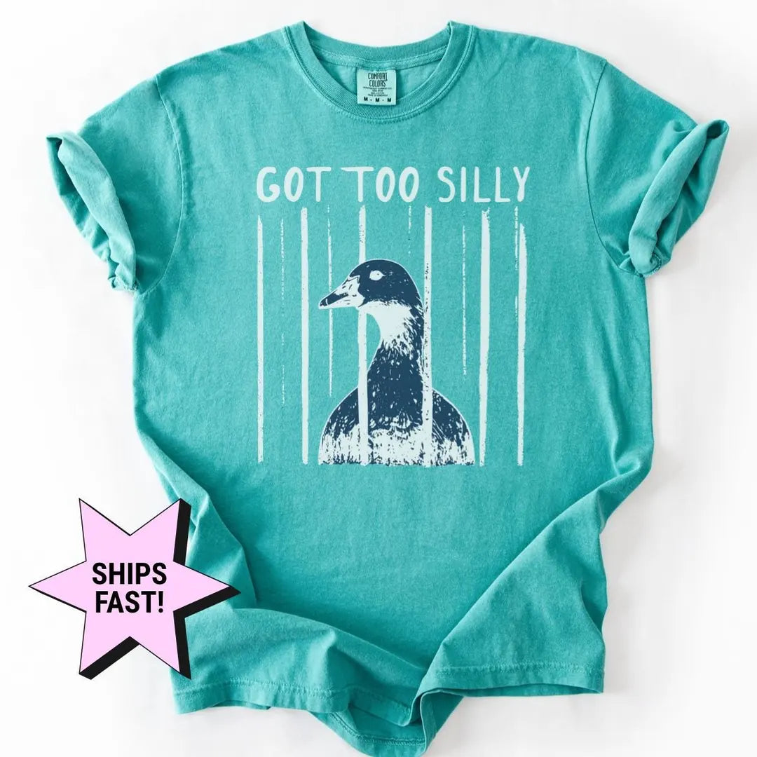 Seafoam teal Comfort Colors tee with sleeves rolled, flat on white, got too silly above a goose head and white stripes