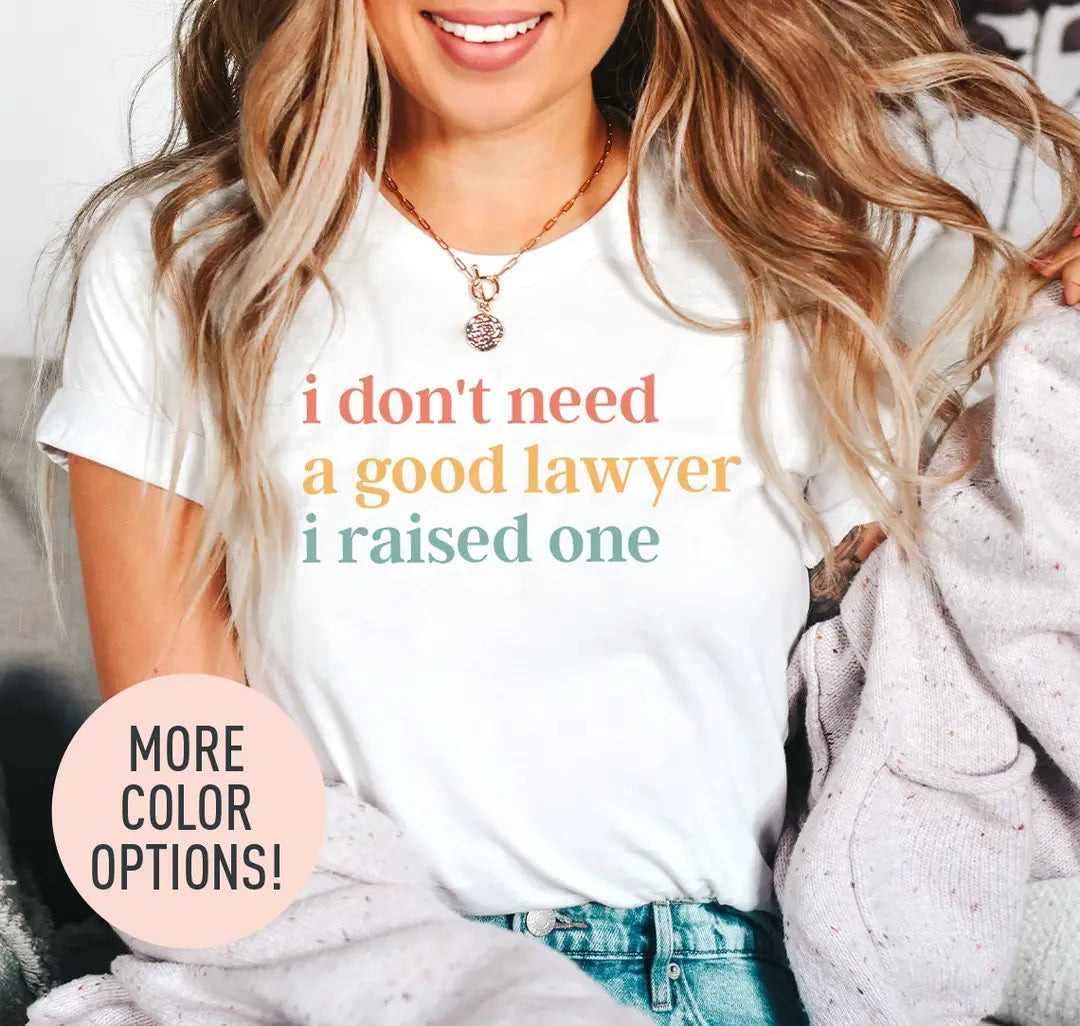 Woman in a white tee and a lilac cardigan, i don't need a good lawyer i raised one in coral, mustard and sage serif