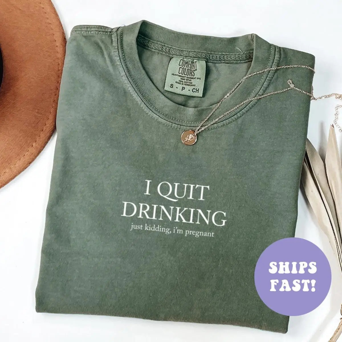 Folded Moss green Comfort Colors tee printed I QUIT DRINKING with the small just kidding, i'm pregnant text below