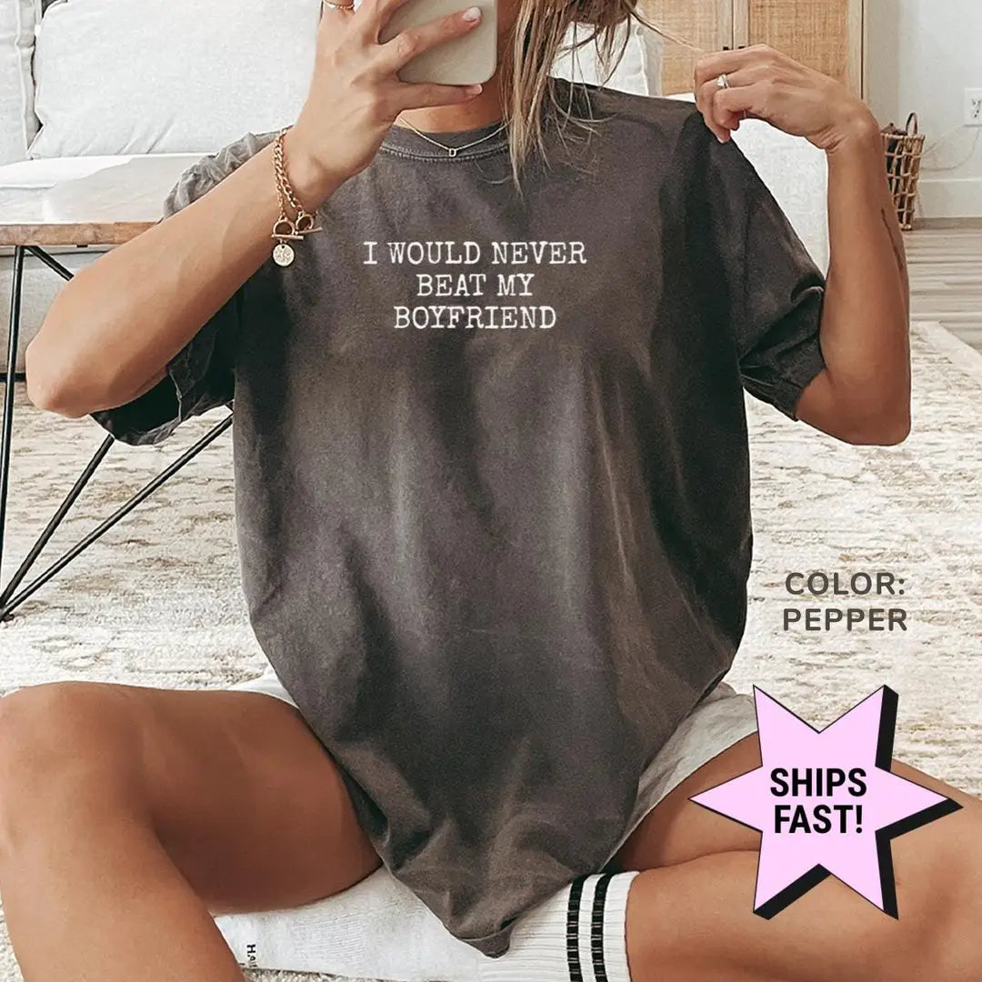 Woman in a Pepper Comfort Colors tee taking a mirror selfie, never beat my boyfriend in small white typewriter capitals