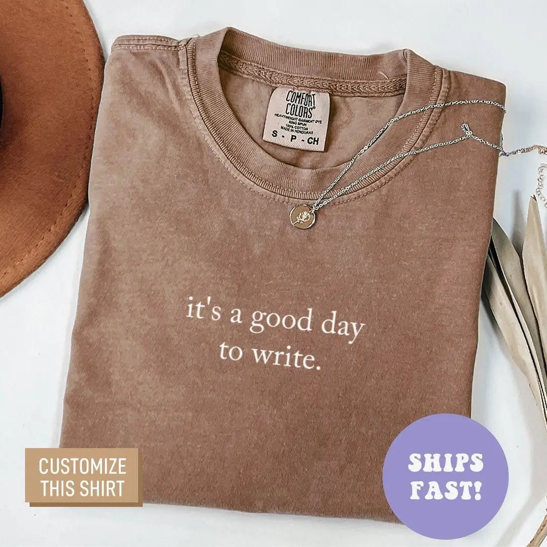 Folded Espresso brown Comfort Colors tee with the good day to write quote in light serif, necklace on the collar