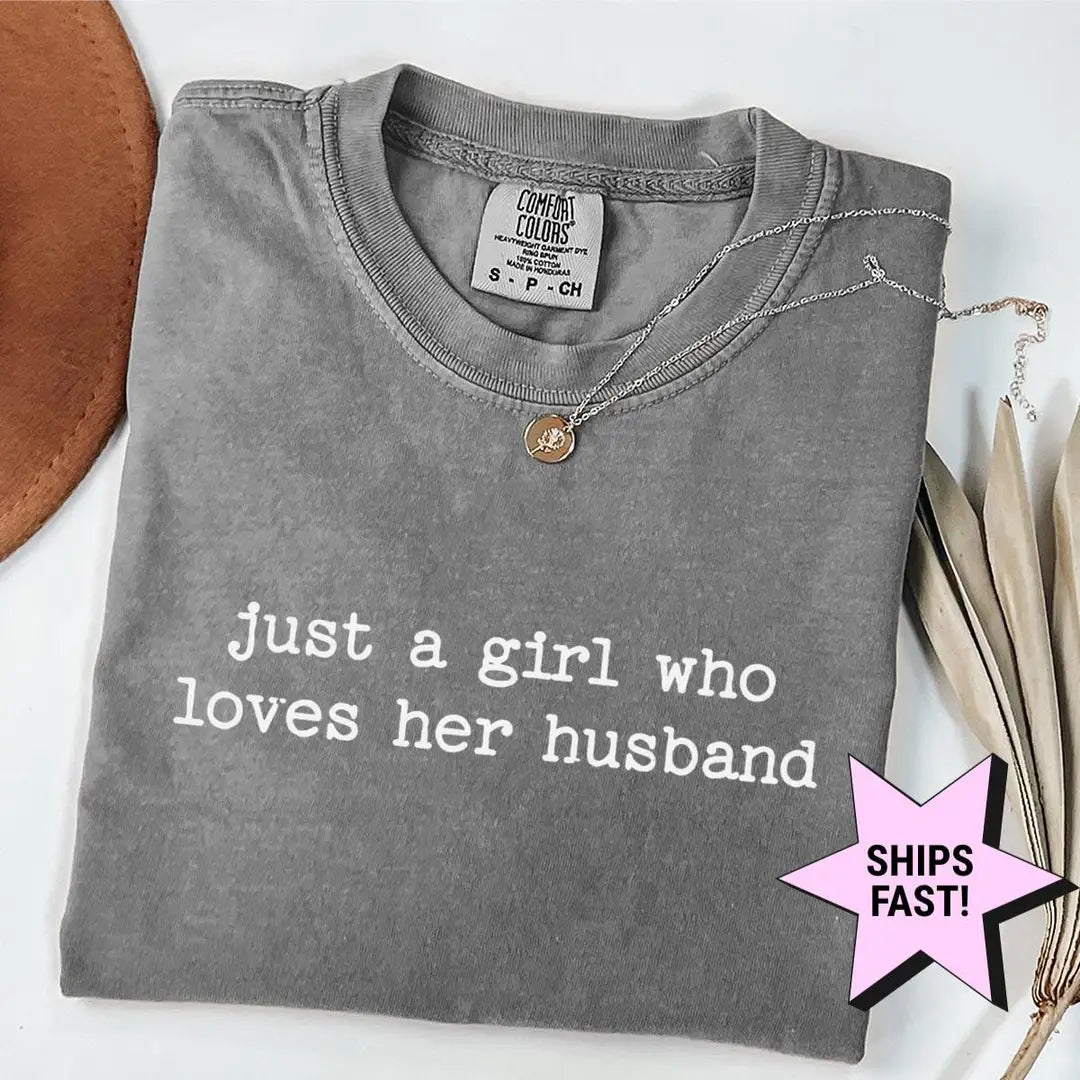 Folded Pepper Comfort Colors tee with just a girl who loves her husband in white typewriter type, necklace at the collar