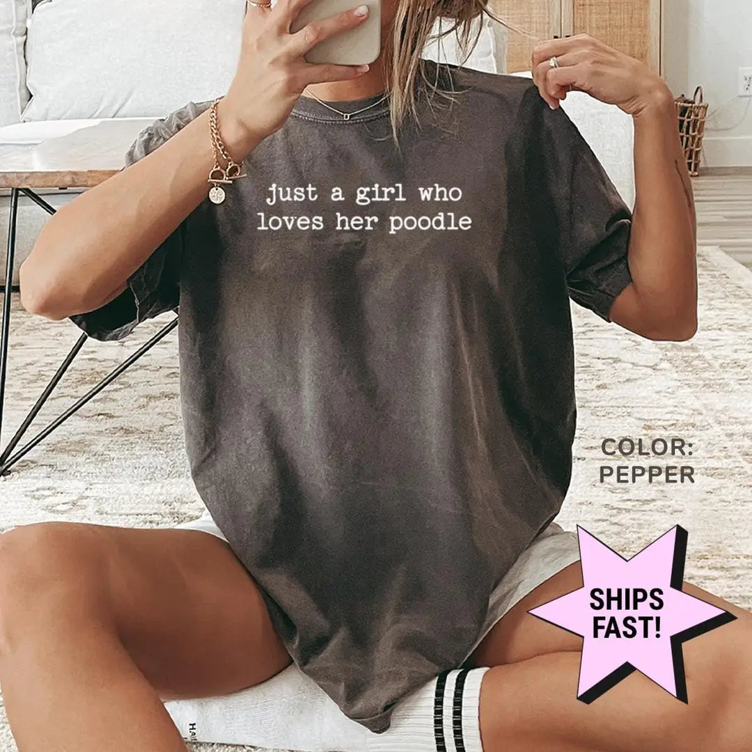 Woman in a Pepper Comfort Colors tee taking a mirror selfie, the girl who loves her poodle quote in small white type