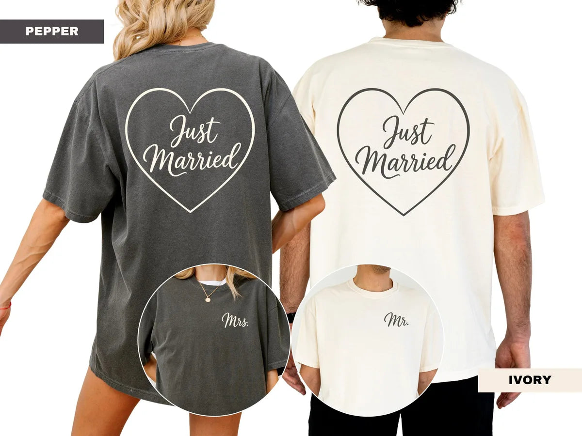 Couple seen from behind in Pepper and Ivory Comfort Colors tees, each with a script just married inside a heart outline