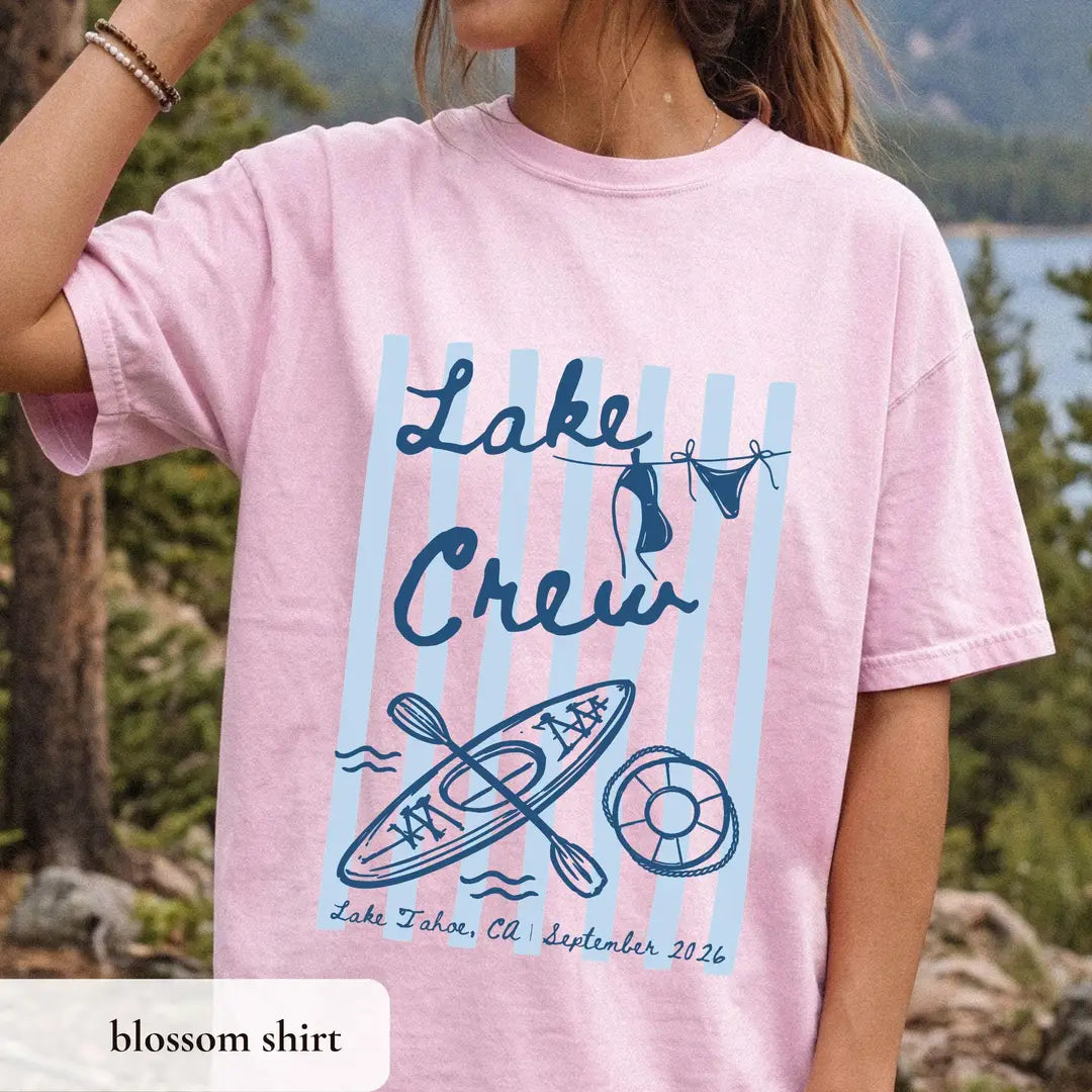 Woman in a Blossom pink Comfort Colors tee at a lake overlook, navy lake crew over blue stripes with kayak and life ring