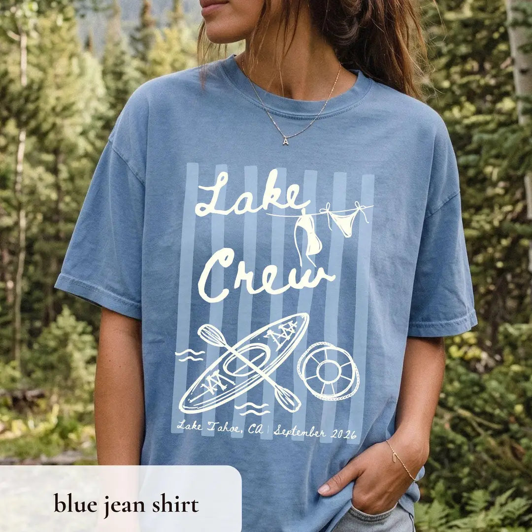 Woman in a Blue Jean Comfort Colors tee in a pine forest, ivory lake crew over stripes with a kayak and life ring