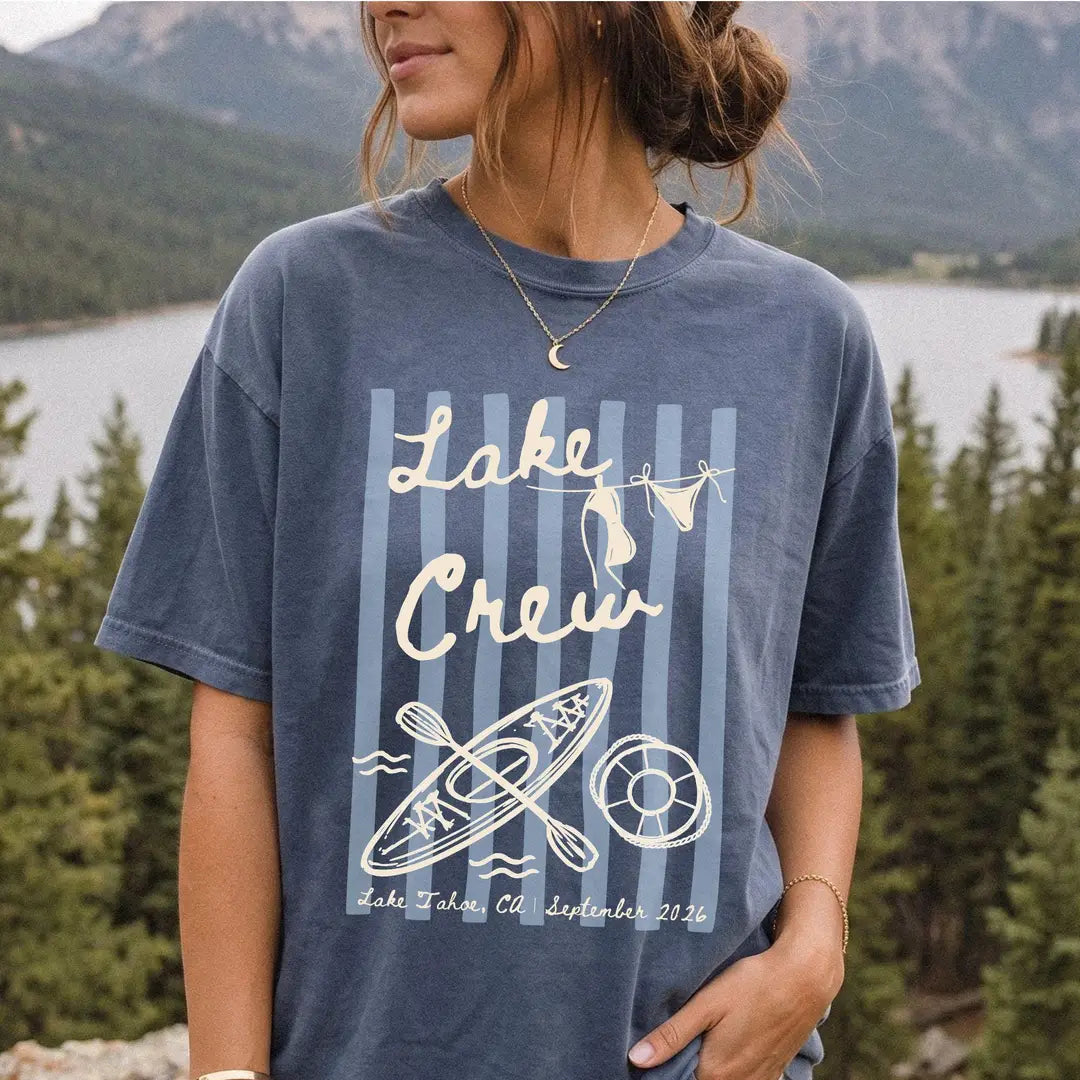 Woman in a Denim Comfort Colors tee, hand in her pocket, ivory lake crew over stripes, bikini clothesline and kayak