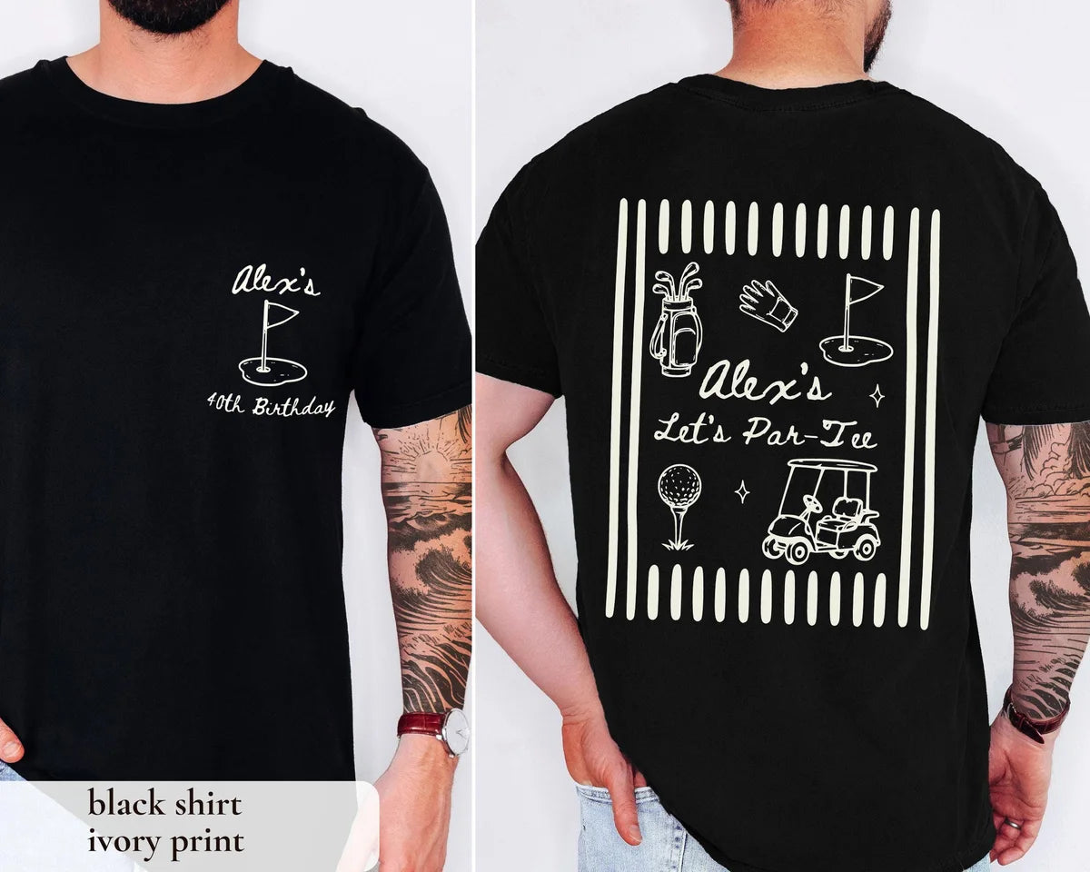 Man in a Black Comfort Colors tee, front with an ivory golf flag and Alex's, back with golf doodles and Let's Par-Tee