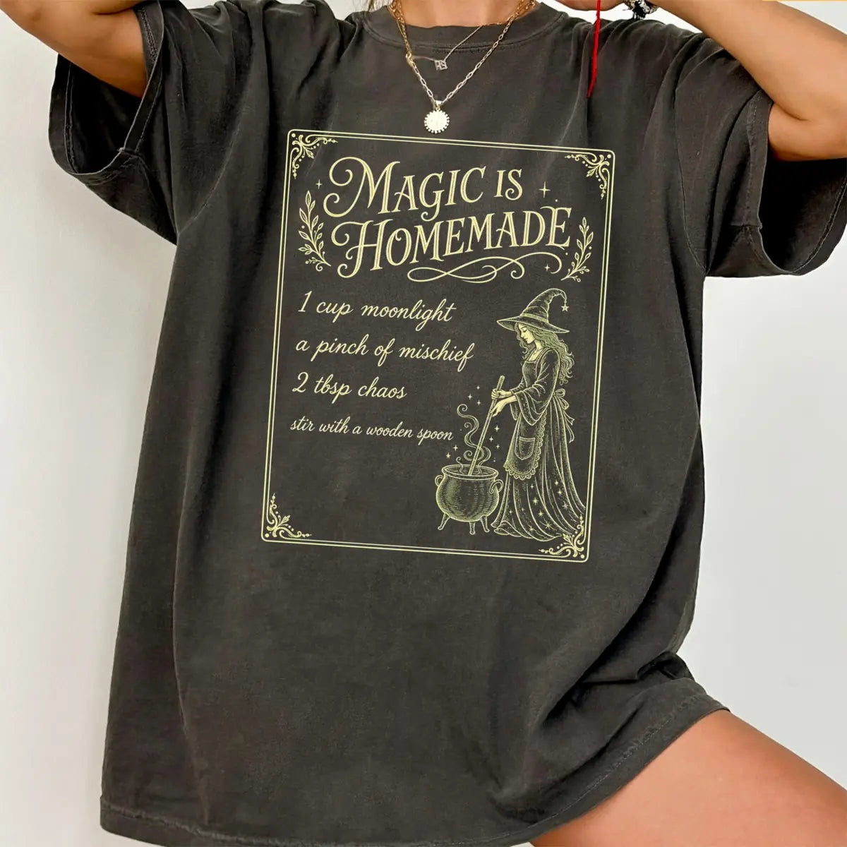 Comfort Colors T-shirt in Pepper color worn by model featuring Magic Is Homemade witch recipe graphic