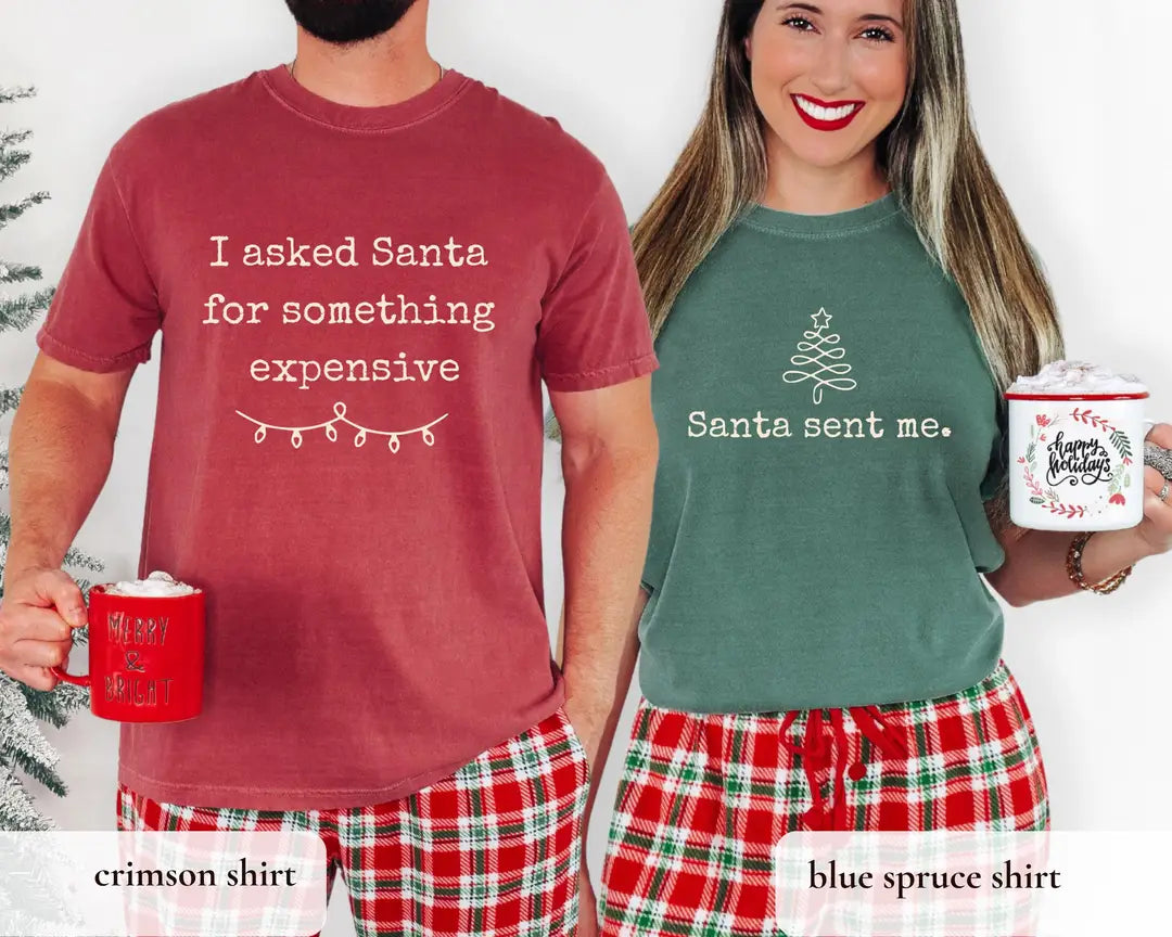 Matching Christmas couple T-shirts in Crimson and Blue Spruce, featuring 'I asked Santa for something expensive' and 'Santa sent me' designs.